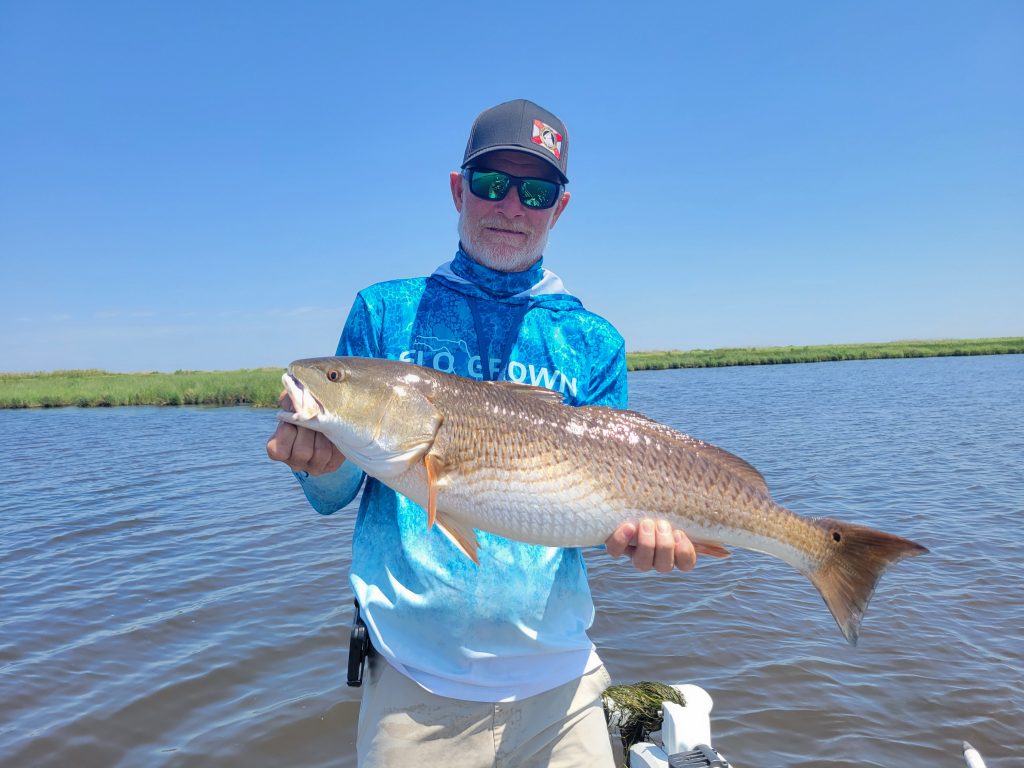 Man holding up fish in Weeki Wachee FL